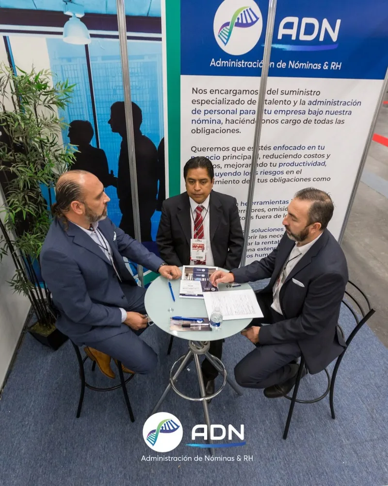 ADN Services executives in a client consultation at an HR expo